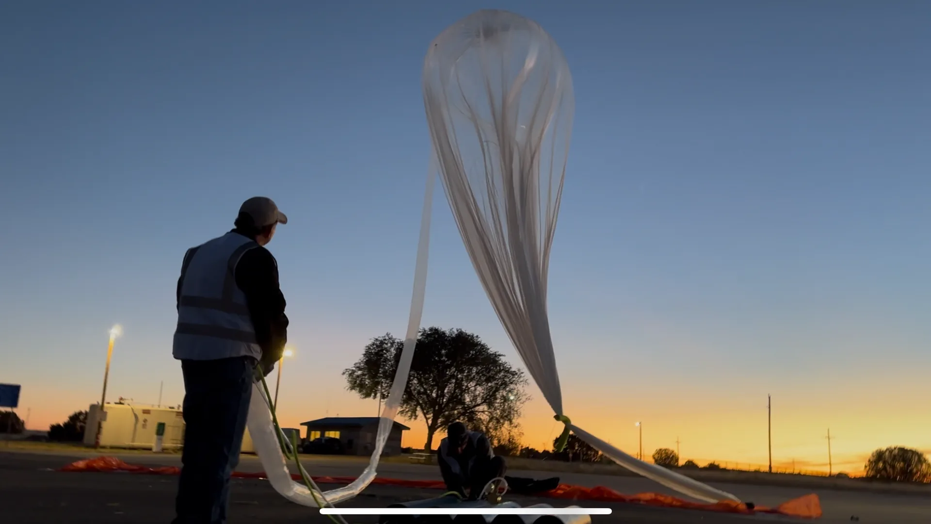 StratoStar crew filling a near-space balloon at sunset