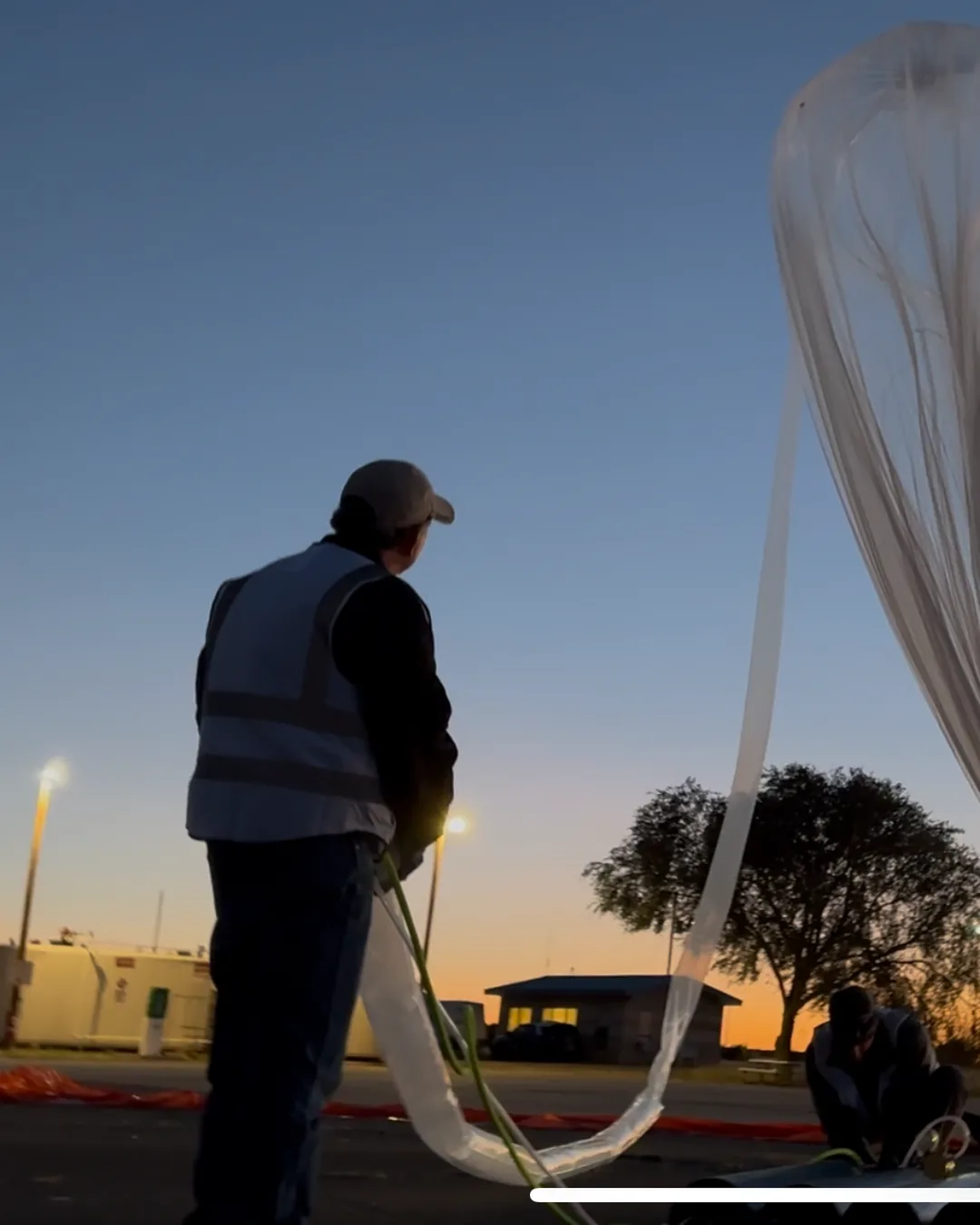 StratoStar crew filling a near-space balloon at sunset