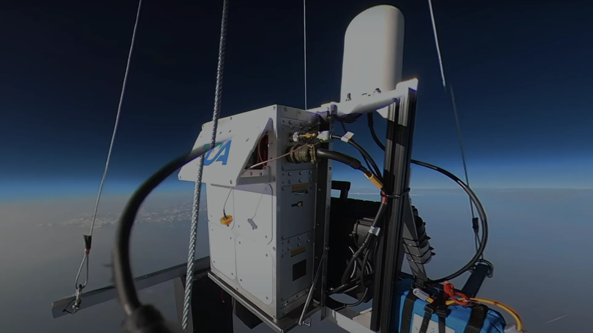 StratoStar payload in near-space flight with the curvature of the Earth behind it