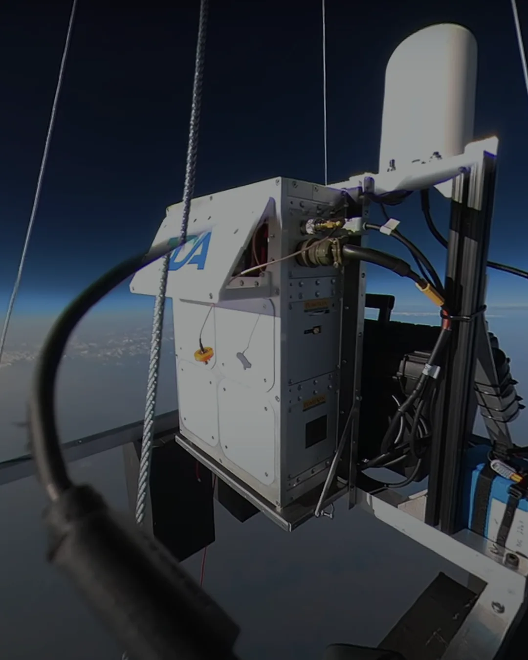 StratoStar payload in near-space flight with the curvature of the Earth behind it