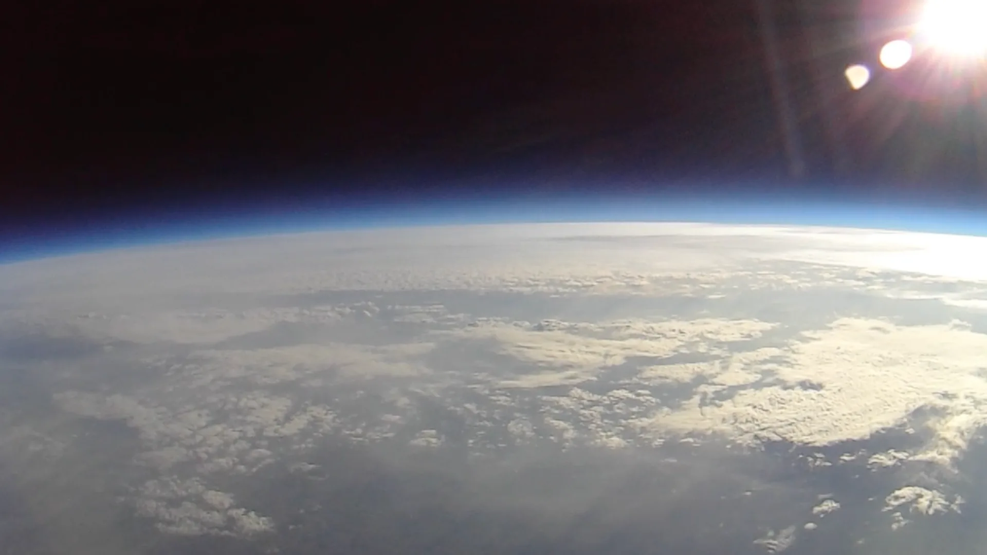 The view from the stratosphere — Earth's curvature, the thin blue atmosphere, and the black of space