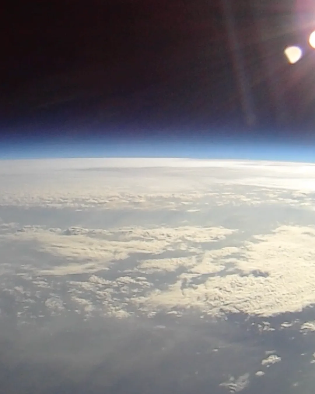 The view from the stratosphere — Earth's curvature, the thin blue atmosphere, and the black of space